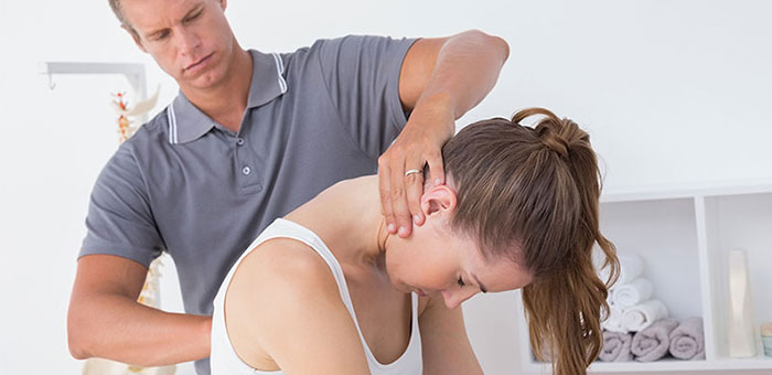 Woman receiving chiropractic adjustment from a Louisville chiropractor