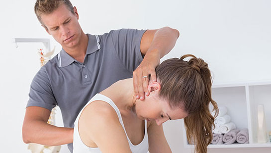 Woman receiving chiropractic adjustment from a Louisville chiropractor