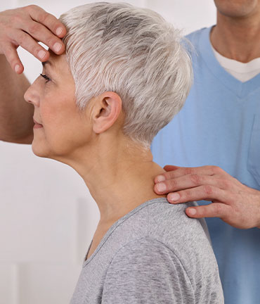 Patient receiving chiropractic adjusmtent for migraine relief from Louisville Chiropractors