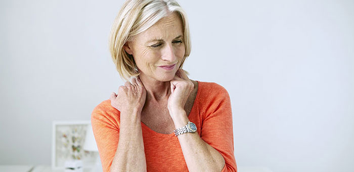 Mature woman suffering from neck and shoulder pain before visiting Louisville chiropractor
