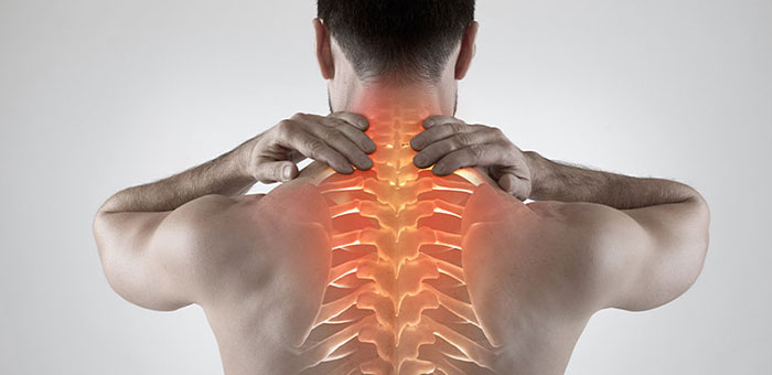 Man with upper back pain before chiropractic treatment from Louisville chiropractor