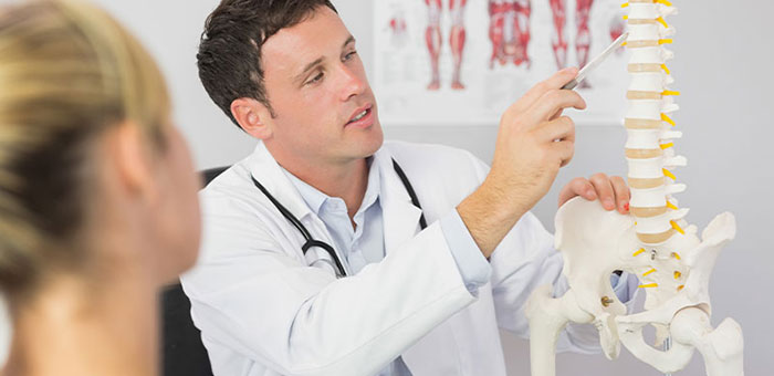 Louisville chiropractor explaining spine misalignments to patient
