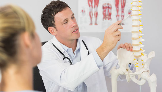 Louisville chiropractor explaining spine misalignments to patient